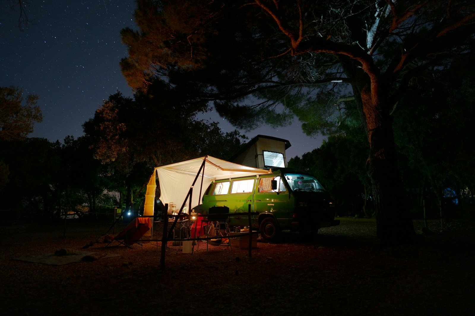 Camper con espacio exterior iluminado durante la noche