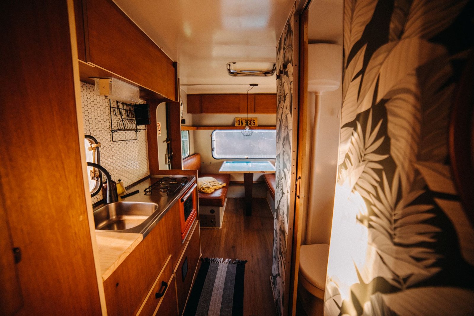 Cocina compacta en el interior de una camper con zona de comedor