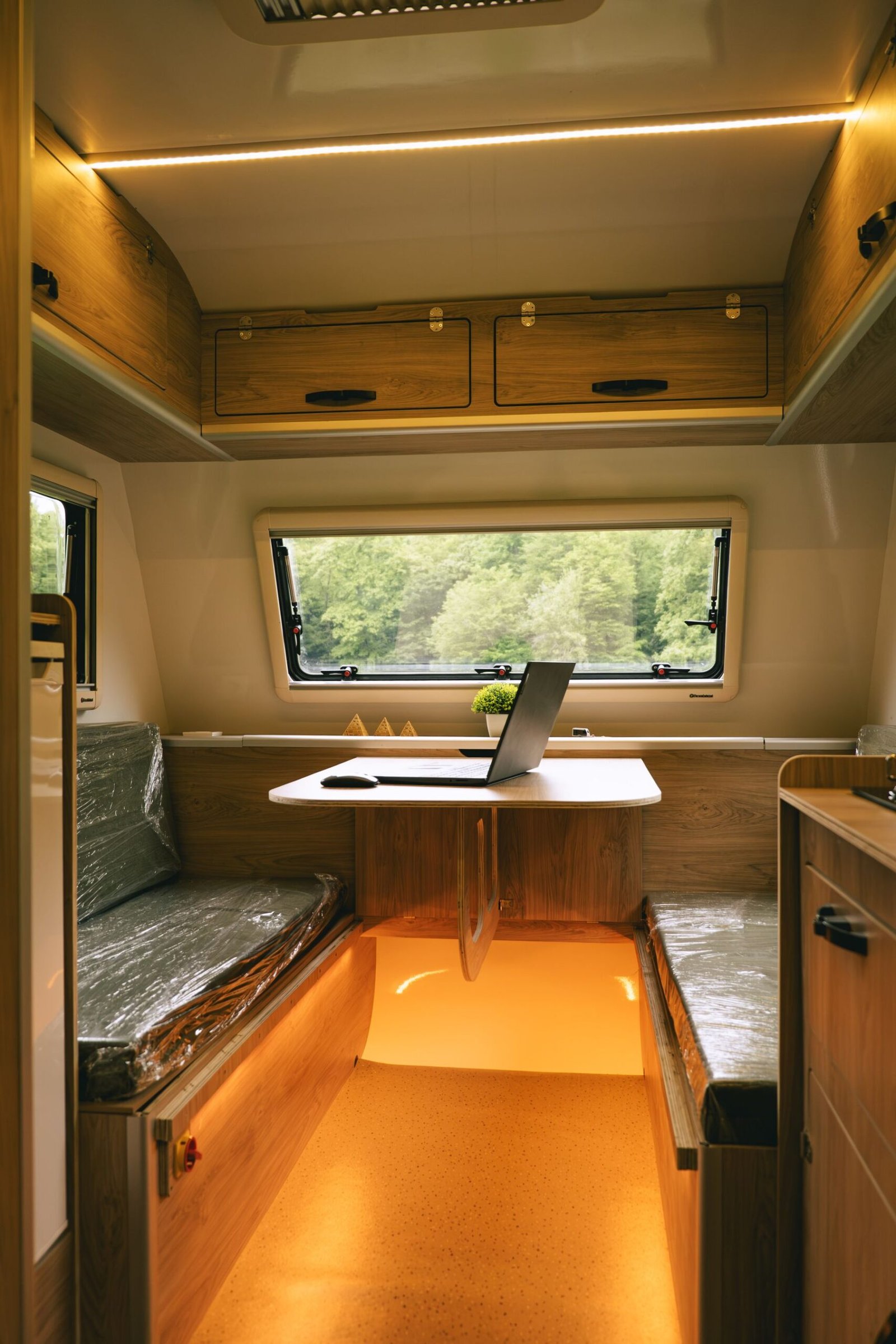Proyecto camper planificado desde un portátil en un entorno natural