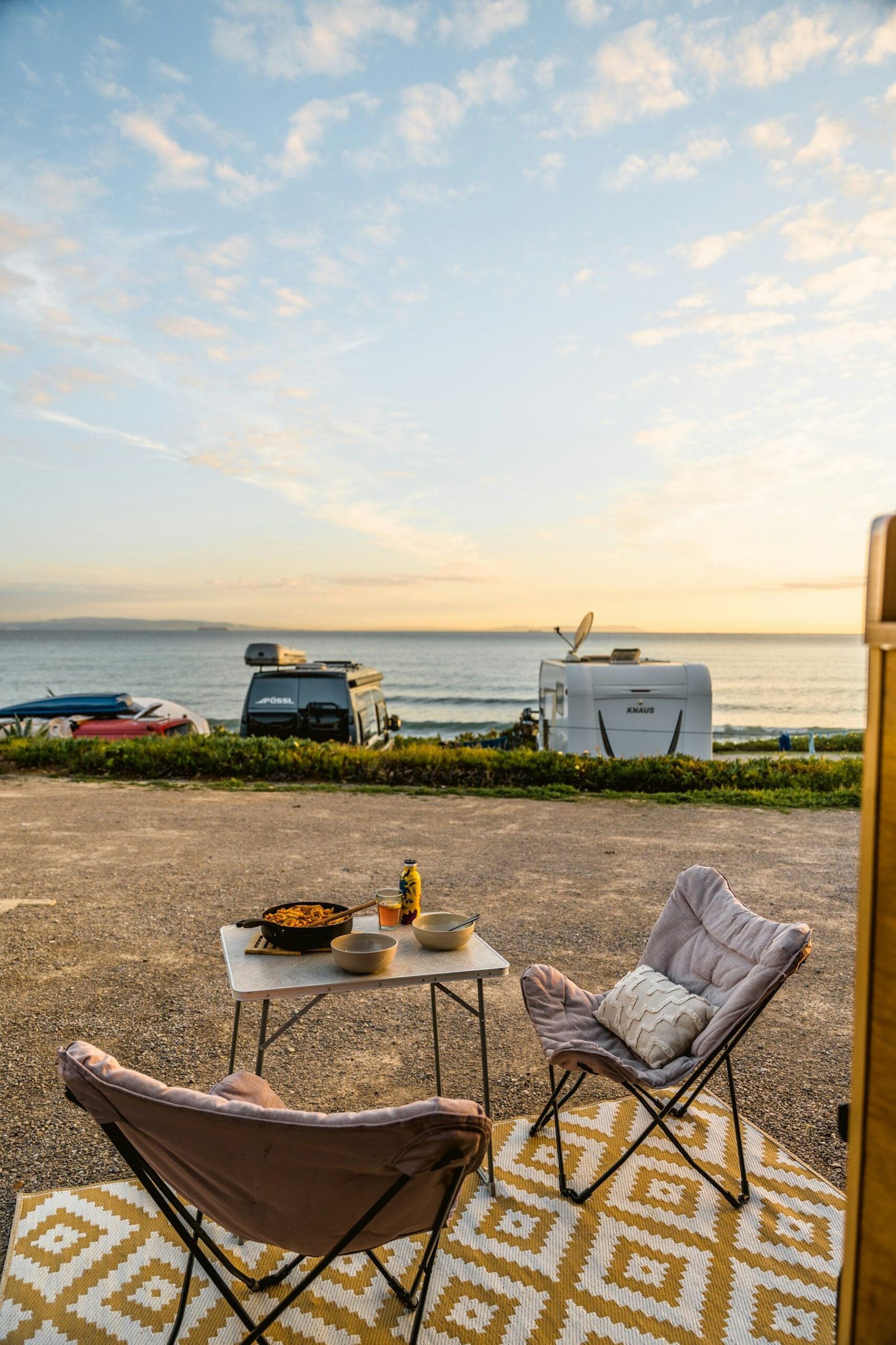 Campers frente al mar al atardecer, inspiración para alquilar una camper en España